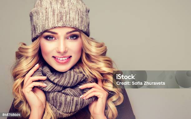 Attractive Blonde Haired Model Dressed In Stylish Knitted Winter Clothes Stock Photo - Download Image Now