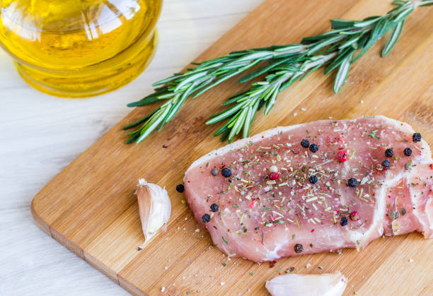 istock Raw fresh meat and seasoning on dark background 848773370