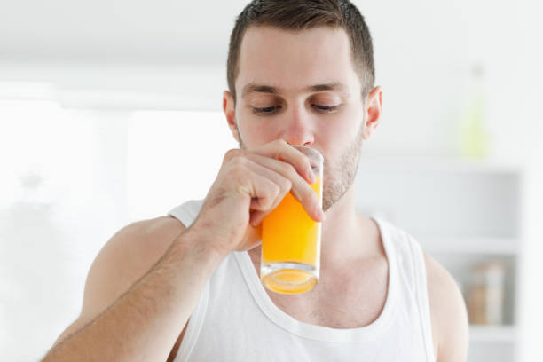 istock Attractive man drinking orange juice 848787168