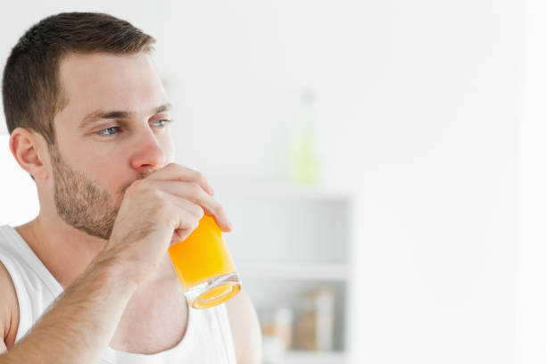 istock Portrait of a delighted man drinking orange juice 848787256