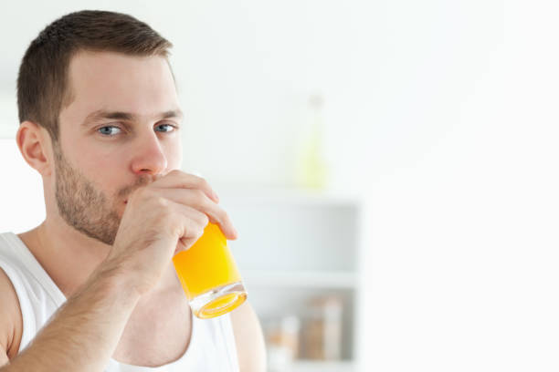 istock Portrait of a good looking man drinking orange juice 848787276
