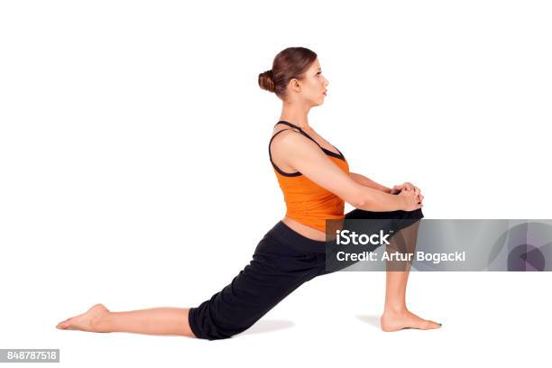 Fit Attractive Woman Practicing Yoga Stretching Pose Stock Photo - Download Image Now