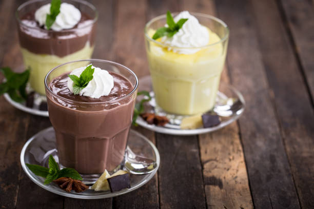 Chocolate and vanilla pudding with whipped cream stock photo