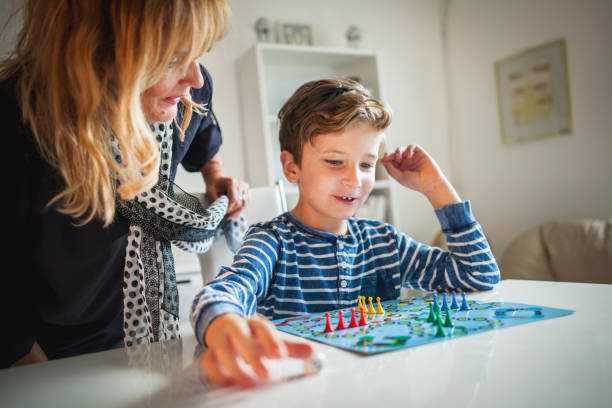 istock Grandmother and grandson playing boards game 848800792