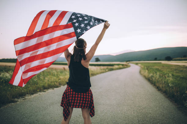istock Woman holding US flag 848804462