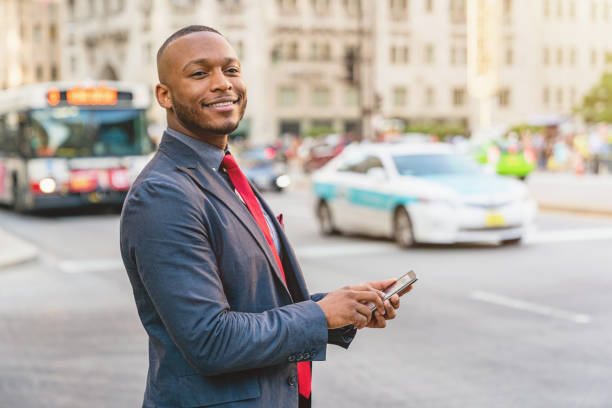istock Smiling Businessman using taxi app to commute in Chicago 848804716