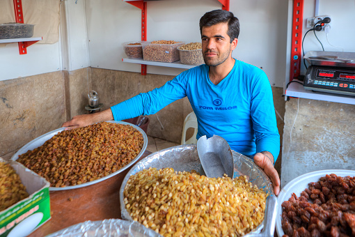 Fars Province, Shiraz: The Iranian sells dried fruits on the street market.