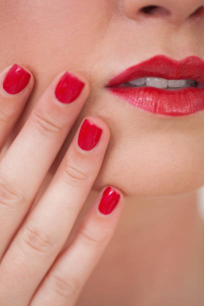 istock Woman red painted finger nails and red lips 848810378