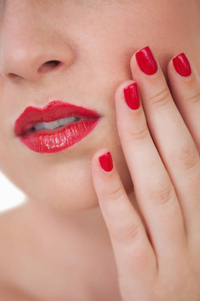 istock Woman red painted finger nails and red lips 848810456