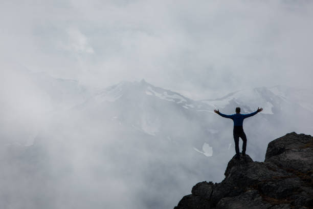 istock Successful male hikers stands arms outstretched 848818066