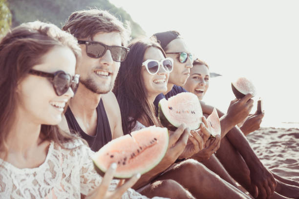 istock Friends eating watermelon on beach 848821948