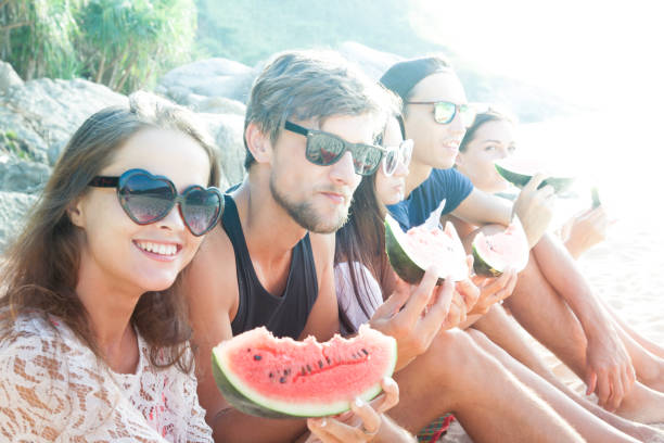 istock Friends eating watermelon on beach 848821960