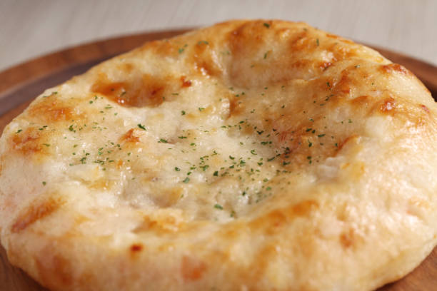 istock focaccia pizza bread isolated on a wood plate on table 848833168