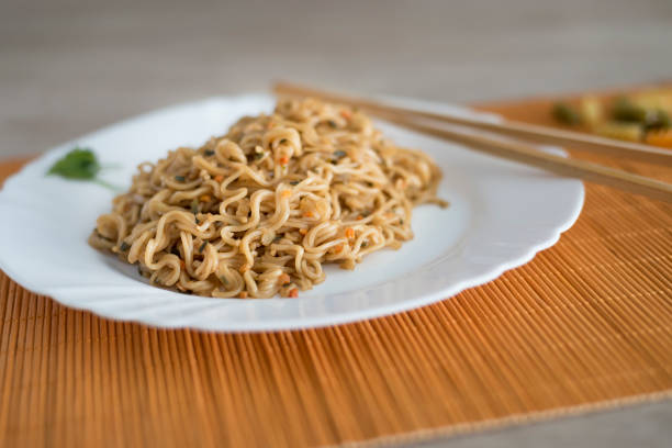 Yakisoba / noodles with beef in rectangle plate with bamboo sticks on a table