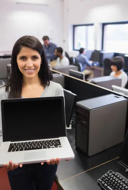 Photo of Woman presenting a laptop