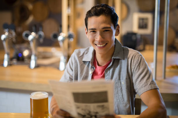 istock Man holding newspaper in a restaurant 848841832