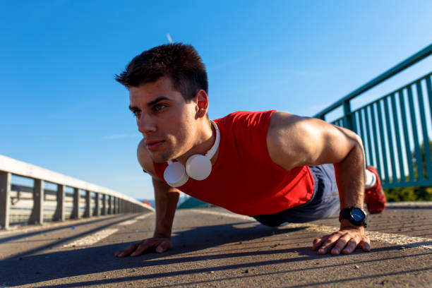 istock Portrait of young athlete man doing push ups on bridge. 848848152