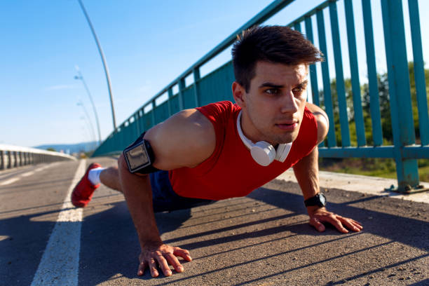 istock Portrait of young athlete man doing push ups on bridge. 848850184