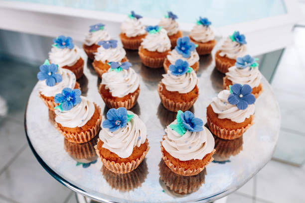 istock Cupcakes with whipped cream and frosting on a silver table in stainless steel 848853926