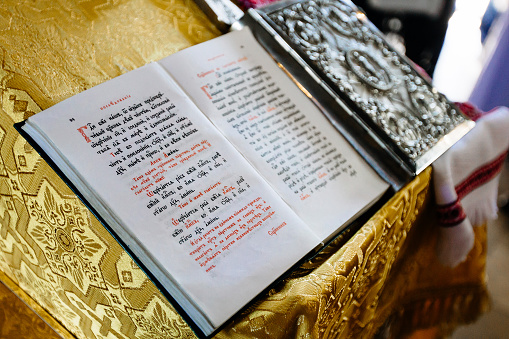 bible on reading-desk or lectern, sacred lectern in the church decorated with golden friezes and ornaments