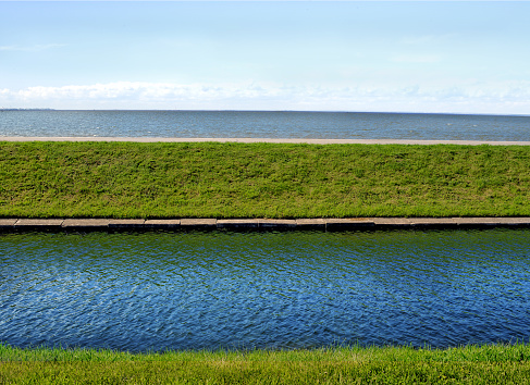 River and sea in parallel with green grass (with a greetings to Andreas Gursky)