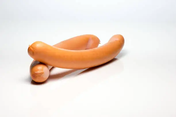 Two sausages set against white background