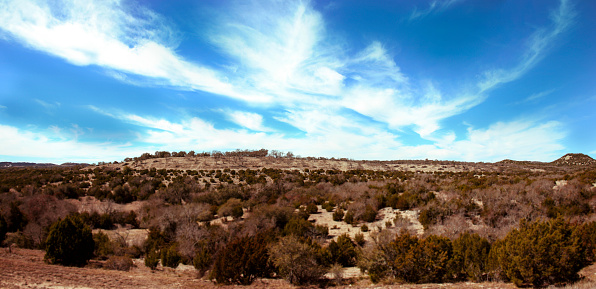 Panorama, landscape of the Texas Hill Country area.  Beautiful sky with dry arid landscape below.  No people.