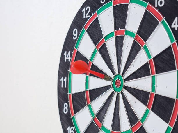 istock Red dart arrow hitting on center target of dartboard. 848862948