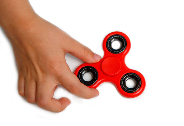 istock girl hand holding popular fidget spinner toy 848868458