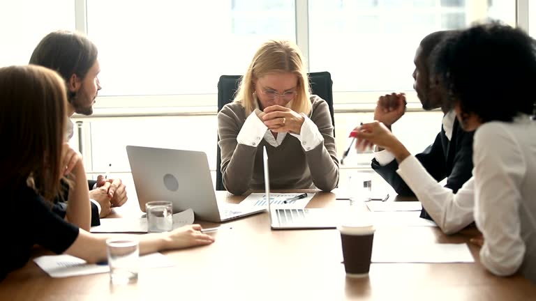 Stressed overwhelmed female boss feels angry about multitasking difficult job