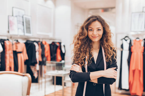 Making fashion Beautiful woman standing with arms crossed in a fashion store boutique stock pictures, royalty-free photos & images
