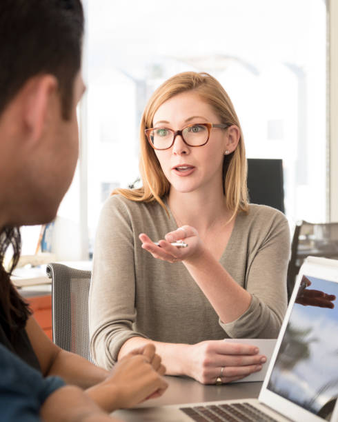 istock Young woman discussing work with colleague 848878274