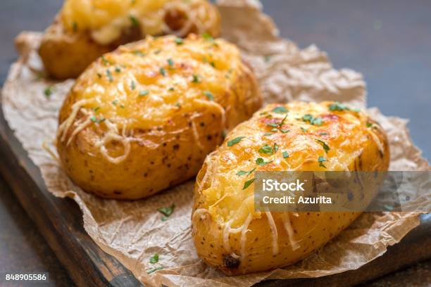 Baked Loaded Potato With Bacon Cheese And Onion Stock Photo - Download Image Now - Baked Potato, Cheese, Prepared Potato