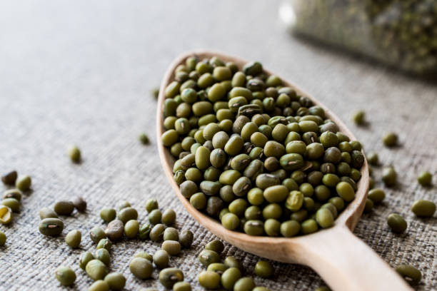 istock Mung Beans in wooden spoon. 848906076