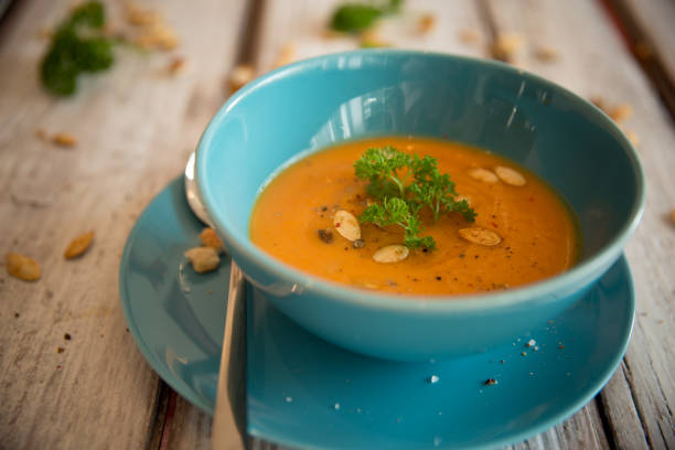 istock Pumpkin soup served with parsley and pumpkin seeds 848906498
