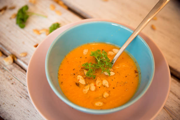 istock Pumpkin soup served with parsley and pumpkin seeds 848909172