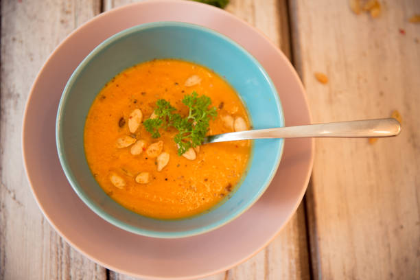 istock Pumpkin soup served with parsley and pumpkin seeds 848909192