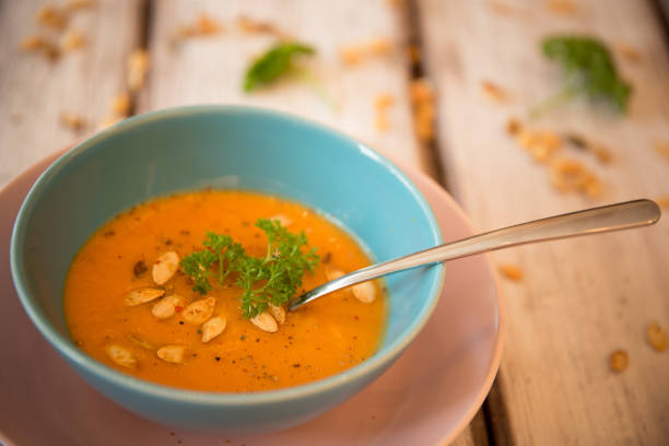 istock Pumpkin soup served with parsley and pumpkin seeds 848909222