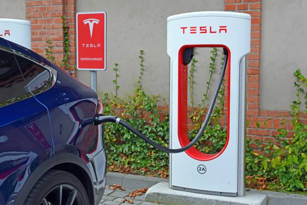 Tesla Model X on the electric charging point Poznan, Poland - 13 September, 2017: Supercar Tesla Model X parked on the public Tesla Supercharger charging point. Tesla had 861 station network boasts with 5655 Superchargers in June 2017 in the world. tesla model x stock pictures, royalty-free photos & images