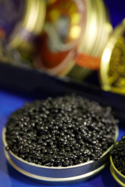 istock Black caviar in a jar. On the blue table. Top view. Close-up background. 848919378