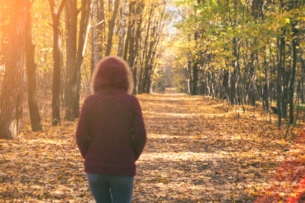 istock Woman in autumn park 848928928