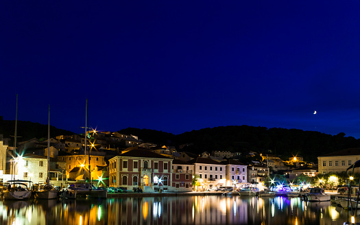 Croatian town Pucisca at night / views from the island of Brac - summer landscape.