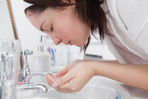 istock Young woman washing face 848933332