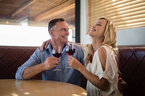 Happy couple having glass of wine in restaurant