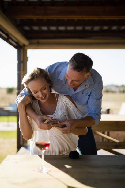istock Smiling man wearing engagement ring to woman 848939256