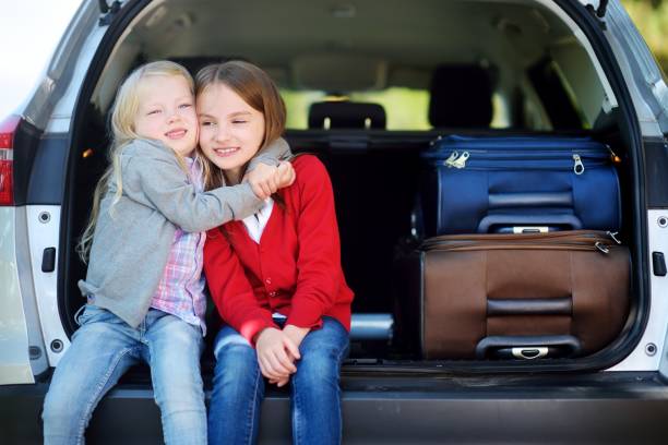 istock Two adorable little sitting in a car before going on vacations with their parents 848942054
