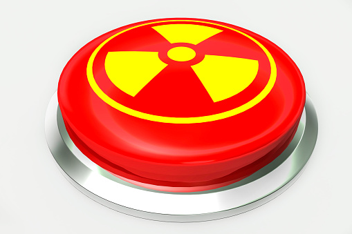 Red nuclear alert button and sign for danger isolated on white background. 3D illustration and rendering