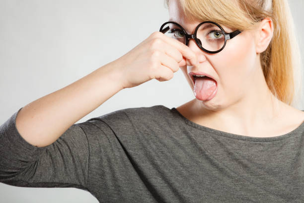 istock Nerdy girl holding nose. 848946912