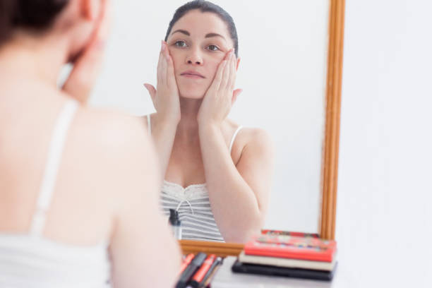 istock Woman applying cream on face 848949286