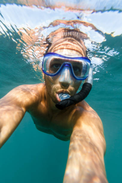 istock Man snorkeling in clear turquoise water 848955812